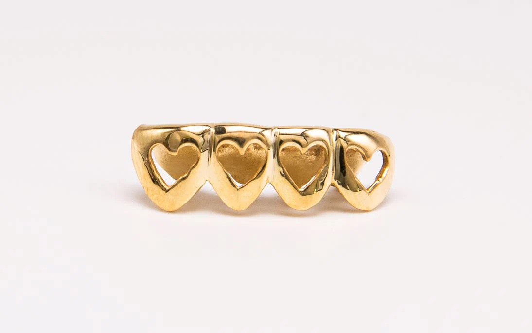 The Hopeless Romantic is a four tooth grill with hearts cutout design!